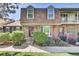 Charming brick townhouse with a well-maintained front yard and a cozy, inviting entrance at 8871 E Amherst Dr # B, Denver, CO 80231