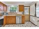 An updated kitchen featuring stainless steel appliances and checkered flooring at 8871 E Amherst Dr # B, Denver, CO 80231