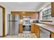 An open kitchen featuring stainless steel appliances and checkered flooring at 8871 E Amherst Dr # B, Denver, CO 80231