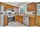 An updated kitchen featuring stainless steel appliances and checkered flooring at 8871 E Amherst Dr # B, Denver, CO 80231