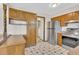 An open kitchen featuring stainless steel appliances and checkered flooring at 8871 E Amherst Dr # B, Denver, CO 80231