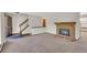 Open living area with fireplace, and staircase providing easy access to the upper level at 8871 E Amherst Dr # B, Denver, CO 80231