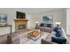 Comfortable living room with a brick fireplace, stylish sofas, and inviting decor at 8871 E Amherst Dr # B, Denver, CO 80231