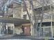 Exterior view of condo building with covered parking and bare trees in winter at 1302 S Parker Rd # 127, Denver, CO 80231