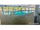 Bright indoor pool area with floor-to-ceiling windows and blue water at 1302 S Parker Rd # 127, Denver, CO 80231