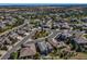 Aerial view showing a neighborhood with luxury homes, tree-lined streets, and open space at 7144 Galaxy Ct, Castle Rock, CO 80108