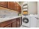 Laundry room with washer, dryer, and ample cabinet space at 7144 Galaxy Ct, Castle Rock, CO 80108