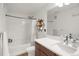 Bright bathroom with a shower-tub combo, modern vanity, and stylish shelving unit at 9227 Rolling Way # 201, Parker, CO 80134
