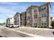Apartment building exterior featuring balconies, stone accents, and designated parking spaces at 9227 Rolling Way # 201, Parker, CO 80134