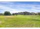 Spacious community green space with lush lawns and multiple dwelling buildings in the background at 9227 Rolling Way # 201, Parker, CO 80134