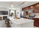 Bright kitchen features quartz countertops, stainless appliances, stylish backsplash, and seating at the island at 9227 Rolling Way # 201, Parker, CO 80134