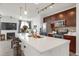 Bright kitchen features quartz countertops, stainless appliances, stylish backsplash, and seating at the island at 9227 Rolling Way # 201, Parker, CO 80134