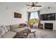 Bright living room with cozy sectional, modern ceiling fan and view of the outdoors at 9227 Rolling Way # 201, Parker, CO 80134