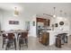 Well-lit living space with a large island, stainless steel appliances, dining, and living area at 9227 Rolling Way # 201, Parker, CO 80134