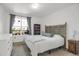 Main bedroom with an antique headboard and views from the window of the outside balcony at 9227 Rolling Way # 201, Parker, CO 80134