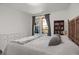 Bright bedroom featuring natural light and views from the window of the outside balcony at 9227 Rolling Way # 201, Parker, CO 80134