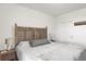 Well-lit main bedroom features unique headboard, side tables, and an easily accessible laundry area at 9227 Rolling Way # 201, Parker, CO 80134