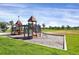 Community playground area with slides and climbing equipment surrounded by green lawn at 9227 Rolling Way # 201, Parker, CO 80134