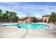 Inviting community pool with a clubhouse in the background and plenty of seating for residents at 9227 Rolling Way # 201, Parker, CO 80134