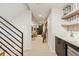 Finished basement with a bar and drink refrigerator next to modern stairs at 4651 Alcott St, Denver, CO 80211