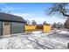 Backyard view with a new wood fence and mature trees at 469 S Perry St, Denver, CO 80219