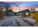 Backyard featuring detached garage, driveway, and updated landscaping at 469 S Perry St, Denver, CO 80219