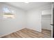 Neutral bedroom featuring a window for natural light and an open doorway at 469 S Perry St, Denver, CO 80219