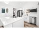 Modern kitchen featuring stainless appliances and center island cooktop at 469 S Perry St, Denver, CO 80219