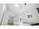 Newly renovated kitchen with vaulted ceilings, modern lighting, and sleek white countertops at 469 S Perry St, Denver, CO 80219