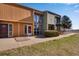 Exterior of the condo showing the sidewalk out front and well maintained landscaping with large windows on the second level at 10390 Tumbleweed Dr # 7, Thornton, CO 80229