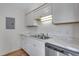 Well-organized kitchen with white cabinets, modern countertops, and stainless dishwasher at 10390 Tumbleweed Dr # 7, Thornton, CO 80229