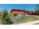 Red brick house on a grassy lot with a tree stump in the yard at 2533 E 90Th Pl, Thornton, CO 80229