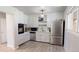 Bright kitchen featuring white cabinets, stainless steel appliances, and neutral flooring at 2533 E 90Th Pl, Thornton, CO 80229