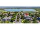 Aerial view of a neighborhood featuring a lake, tree-lined streets and well maintained homes at 2488 Lake Vista Dr, Broomfield, CO 80023