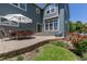 Backyard patio with outdoor seating, umbrella, lush landscaping, and inviting outdoor space at 2488 Lake Vista Dr, Broomfield, CO 80023