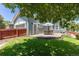 Inviting back yard featuring a patio seating area, lush green grass, and shade trees at 2488 Lake Vista Dr, Broomfield, CO 80023