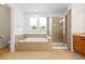 Bright bathroom features a soaking tub, walk-in shower and neutral tile at 2488 Lake Vista Dr, Broomfield, CO 80023