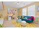 A stylish bedroom with colorful decor, a cozy sofa, and lots of natural light at 2488 Lake Vista Dr, Broomfield, CO 80023