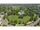 Aerial view of a community park with a large pool, green spaces, and walking paths in a suburban neighborhood at 2488 Lake Vista Dr, Broomfield, CO 80023