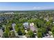 Aerial shot showcases a community center and pool surrounded by trees and neighborhood homes in a suburban area at 2488 Lake Vista Dr, Broomfield, CO 80023