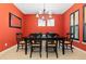 Elegant dining room with black furniture set against a bright red wall at 2488 Lake Vista Dr, Broomfield, CO 80023
