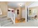 Inviting entryway with hardwood floors, staircase with white railing, and neutral paint throughout at 2488 Lake Vista Dr, Broomfield, CO 80023