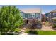 Attractive two-story home with a landscaped front yard, lush greenery and a sidewalk at 2488 Lake Vista Dr, Broomfield, CO 80023