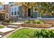 Charming front entrance featuring stone accents, a well-maintained lawn, and lush landscaping at 2488 Lake Vista Dr, Broomfield, CO 80023