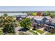 Charming two-story home with manicured lawn, lush trees, and neighborhood lake views on a sunny day at 2488 Lake Vista Dr, Broomfield, CO 80023