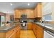 Beautiful kitchen with stainless steel appliances, granite countertops, central island, and wood cabinets at 2488 Lake Vista Dr, Broomfield, CO 80023