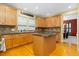 Charming kitchen featuring granite countertops, a central island, stainless appliances, and wood cabinets at 2488 Lake Vista Dr, Broomfield, CO 80023
