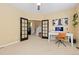 This office features neutral walls, carpet flooring, and black french doors leading to the entryway at 2488 Lake Vista Dr, Broomfield, CO 80023