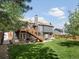 Spacious backyard featuring a deck, large lawn, and a beautifully landscaped outdoor area at 5342 S Halifax Cir, Centennial, CO 80015