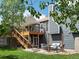 Expansive backyard featuring a multi-level deck, patio, and lush lawn, perfect for outdoor living and entertainment at 5342 S Halifax Cir, Centennial, CO 80015